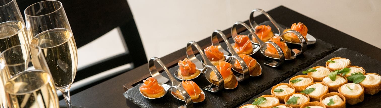 elegantly plated starter dishes arranged neatly on a table at a Christmas catering event in London.
