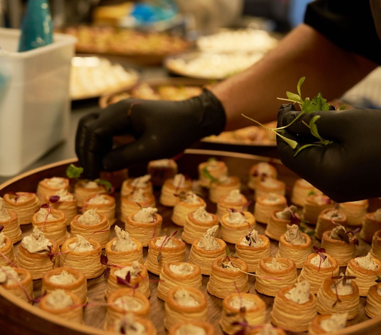 Chef decorating canapés ready for serving